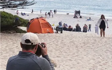  ?? Photos by Carl Nolte / The Chronicle ?? Tourists visit the beach in Carmel, which gives visitors an illusion of a wealthy, leisurely life by the sea.