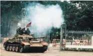  ??  ?? North Vietnamese tank crashes through the cast-iron gate of the presidenti­al palace in Saigon on April 30, 1975