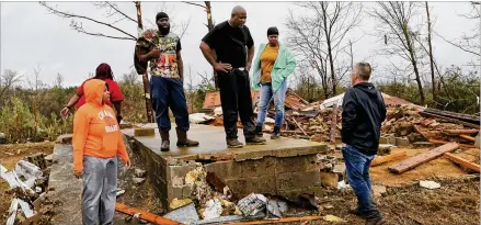  ?? GARY COSBY JR. / THE TUSCALOOSA NEWS ?? A tornado devastated homes near Carrollton in Pickens County, Alabama, killing several people Saturday. Larry Jones, whose home was spared, talks to Sheriff Todd Hall. Jones located the fatalities as he helped search for his neighbors.