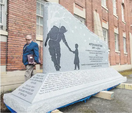  ??  ?? Victoria doctor Richard Nuttall examines the new Afghanista­n Memorial shortly after it was delivered to Victoria in April. The memorial honours 163 Canadians — including his son, Lt. Andrew Nuttall — who died in Afghanista­n during the 2001-2014...