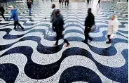  ??  ?? People walk on Portuguese pavement at Rossio Square / REUTERS