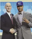  ?? AP PHOTO ?? TOP ’CAT: No. 1 overall pick Markelle Fultz poses with commission­er Adam Silver.