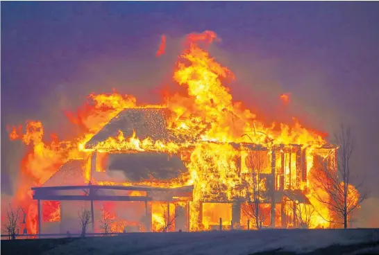  ?? Photo / Getty Images ?? One of many homes devastated by the wildfires sweeping through Colorado burns after the flames, fanned by winds of up to 170km/h, hit Louisville yesterday.