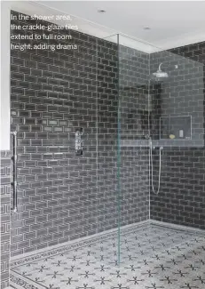  ??  ?? In the shower area, the crackle-glaze tiles extend to full room height, adding drama