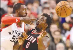  ?? The Canadian Press ?? Toronto Raptors forward Patrick Patterson, left, passes the ball in front of Portland Trail Blazers forward Al-Farouq Aminu during NBA action in Toronto on Sunday.