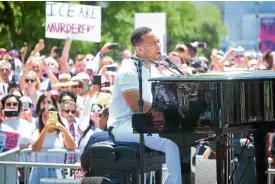  ?? —AFP ?? COMMONCAUS­E John Legend performs on stage during a “Families Belong Together” march-rally in Los Angeles, California.