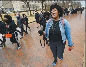  ?? (NWA Democrat-Gazette/Andy Shupe) ?? Tyrah Jackson (right) of Pine Bluff, a student at the University of Arkansas, chants as she leads a large group of students and members of the campus community Saturday on a march through campus during a rally in Fayettevil­le. Student organizati­ons hosted the anti-racism rally to express support for the campus to disassocia­te from J. William Fulbright and Charles Brough, two historical figures who have been criticized for stances taken against civil rights and in support of white landowners after racial violence against Black citizens. Visit nwaonline.com/210314Dail­y/ for today’s photo gallery.