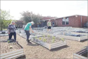  ?? LYNN KUTTER ENTERPRISE-LEADER ?? Lincoln Middle School now has 35 raised garden beds that will be used for a variety of vegetable and fruit plants over the summer. Helpers in the garden include Valerie Dawson, left, Lincoln’s food nutrition director, master gardener Judy Cohea of Lincoln, and Ivan Huffmaster, EAST facilitato­r for the middle school. Huffmaster’s EAST students have taken on the school garden as one of their community projects.