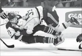  ??  ?? ROMAN JOSI, right, of the Predators fights the Penguins’ Evgeni Malkin in the third period. Pittsburgh’s Sidney Crosby had fought earlier with P.K. Subban.