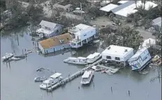  ?? Chris O’Meara/Associated Press ?? Damaged homes sit in the aftermath of Hurricane Irma on Tuesday in Key West, Fla.