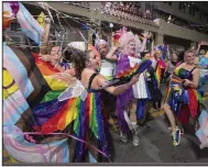  ?? (AP/Florida Keys News Bureau/Andy Newman) ?? Dancers in lavish rainbow-colored attire perform on Duval Street in Key West, Fla., during the Fantasy Fest Parade on Saturday.