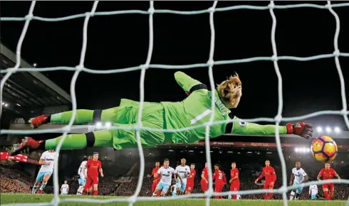  ?? LEE SMITH / REUTERS ?? Liverpool goalkeeper Loris Karius fails to stop a free kick by West Ham United’s Dimitri Payet during their 2-2 Premier League draw at Anfield on Sunday.