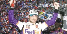  ?? John Raoux / Associated Press ?? In this Feb. 17 file photo, driver Denny Hamlin celebrates in Victory Lane after winning the NASCAR Daytona 500 auto race at Daytona Internatio­nal Speedway in Daytona Beach, Fla. Hamlin closed NASCAR’s iRacing Series virtual auto race with a victory at a simulation of throwback North Wilkesboro Speedway on Saturday.