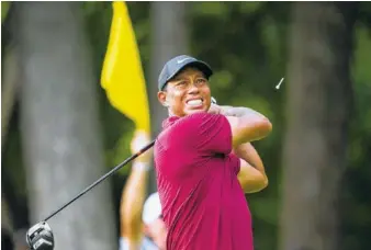  ?? PHOTO BY DOUG MILLS/THE NEW YORK TIMES ?? Tiger Woods tees off on the 16th hole in the final round of the PGA Championsh­ip at Bellerive Country Club in St. Louis on Sunday. Woods finished second after recording a 6-under-par 64 in the final round.