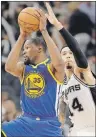  ?? "1 1)050 ?? Golden State Warriors forward Kevin Durant (left) controls the ball in front of San Antonio Spurs’ Danny Green during Game 4 of the NBA Western Conference finals on Monday in San Antonio.