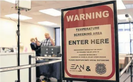  ?? REUTERS/NATHAN FRANDINO ?? A temperatur­e screening area is set up in an office to demonstrat­e the use of Dahua Technology's thermal imaging cameras in San Francisco, Ca. Experts urge bosses to think about how high-tech precaution­s play on the psychology of their workers.