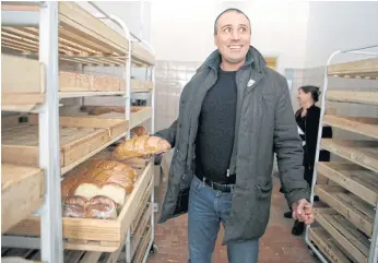  ??  ?? BREAKING BREAD: Here he shown visiting a bakery in Alchevsk, Lugansk district, the separatist-held province of in east Ukraine.