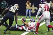  ?? DERICK HINGLE/AP ?? New York Giants running back Saquon Barkley (26) scores a touchdown against New Orleans Saints defensive end Carl Granderson (96) and defensive tackle Shy Tuttle to win in overtime Sunday.