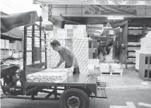  ?? Courtesy of Ali Safavi ?? A man carries paper outside a print shop in Chungmuro.