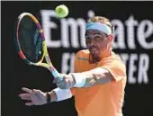  ?? WILLIAM WEST/GETTY-AFP ?? Defending Australian Open champ Rafael Nadal stretches for a return in his opening-round victory against 21-year-old Jack Draper on Monday.