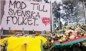  ?? Photograph: Olivier Matthys/EPA-EFE ?? A Sweden team shirt and flowers next to a banner reading 'Courage to the Swedish people during a commemorat­ion for the two fans who were killed by a gunman in Brussels in October.