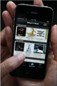  ?? AP FILE ?? An Associated Press reporter demonstrat­es Spotify during a product review in San Francisco, Tuesday, July 19, 2011.