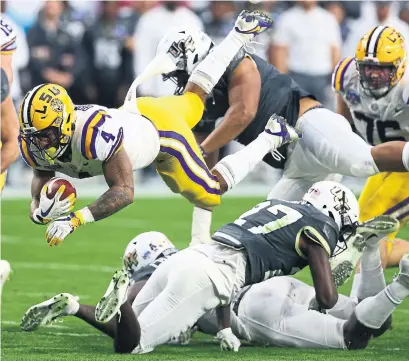  ?? ROSS D. FRANKLIN THE ASSOCIATED PRESS ?? LSU running back Nick Brossette gets upended by UCF defensive back Richie Grant during the Fiesta Bowl on Tuesday.