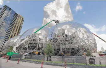  ?? ELAINE THOMPSON/AP ?? Amazon’s campus in downtown Seattle last year while under constructi­on.