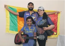  ?? Pawan Singh / The National ?? Dimantha Mark, his wife Natasha Perera and son Devin Mark get ready to cheer on Sri Lanka’s cricketers