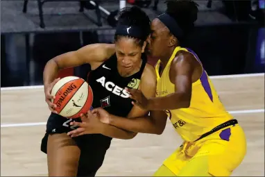  ?? AP PHOTO BY MIKE CARLSON ?? Las Vegas Aces’ A’ja Wilson, left, drives against Los Angeles Sparks’ Nneka Ogwumike during the first half of a WNBA basketball game Saturday, Sept. 12, in Bradenton, Fla.