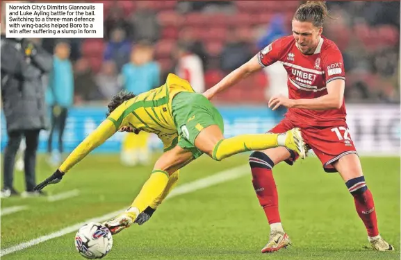  ?? ?? Norwich City’s Dimitris Giannoulis and Luke Ayling battle for the ball. Switching to a three-man defence with wing-backs helped Boro to a win after suffering a slump in form