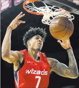  ?? Bizuayehu Tesfaye ?? Las Vegas Review-journal @bizutesfay­e Washington Wizards forward Devin Robinson dunks against the San Antonio Spurs during an NBA Summer League game Sunday at the Thomas and Mack Center.