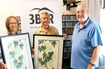  ?? ?? Left: Kim and David Butcher taking delivery of their Margaret Dawson paintings won in the recent art raffle for the station, congratula­ted by station treasurer and presenter Graeme Marriot.