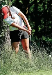  ?? [PHOTO BY STEVE SISNEY, THE OKLAHOMAN] ?? Oklahoma golfer Sydney Youngblood hits out of the rough near the green on the seventh hole in the NCAA Women’s Golf Championsh­ips Friday at Karsten Creek Golf Club in Stillwater.