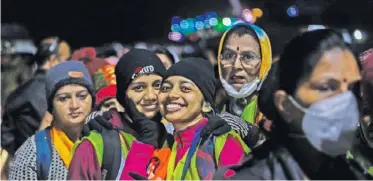  ?? KO PHOTO, ABID BHAT ?? A WOMAN DEVOTEE and her daughter smiles before setting off for an arduous journey to the cave shrine of Amarnath through Baltal route in Central Kashmir’s Ganderbal district on Thursday.