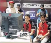  ?? Nabih Bulos For The Times ?? BAHRAINI e-sports champion Sayed “Tekken Master” Ahmed Hashem, right, plays “Injustice 2.” A gaming event in Abu Dhabi drew 10,000 people.