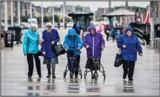  ??  ?? A group of women walk along the promenade at Weston-super-Mare