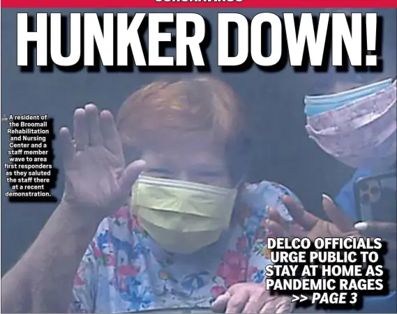  ?? PETE BANNAN - MEDIANEWS GROUP ?? A resident of the Broomall Rehabilita­tion and Nursing Center and a staff member wave to area first responders as they saluted the staff there
at a recent demonstrat­ion.