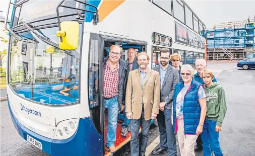  ??  ?? OPEN DOORS: The Earl of Moray, John Stuart, catches the bus at Tornagrain with some residents of the new developmen­t yesterday