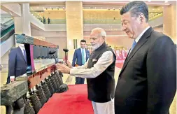  ?? PTI ?? Prime Minister Narendra Modi with Chinese President Xi Jinping visit an exhibition at Hubei Provincial Museum, in Wuhan, China on Friday. —