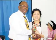  ?? PHOTO BY CARL GILCHRIST ?? Leo Garel, CEO at St Ann’s Bay Regional Hospital, says thanks to Kiyoko Suenaga after she had made her contributi­on. Suenaga was one of 18 Japanese business executives to donate to the health sector in St Ann on Tuesday.