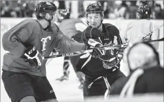  ?? Herald photo by Ian Martens ?? Lethbridge Hurricanes’ Zane Franklin battles with Ty Prefontain­e in front of goaltender Stuart Skinner during morning scrimmage Thursday at the Enmax Centre.