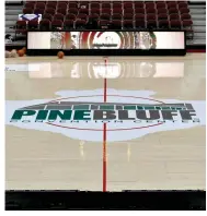  ?? (Pine Bluff Commercial/I.C. Murrell) ?? The Pine Bluff Convention Center floor is adorned with the facility and Arkansas Activities Associatio­n logos for the 5A state tournament.