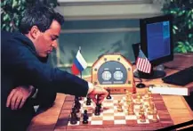  ?? ?? Kasparov makes a move in May 1997 in new york during his fourth game against deep Blue. — AFP