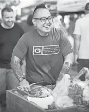  ?? CHRIS HYNES ?? James Beard Award winner Tory Miller, chef and co-owner of L’Etoile in Madison, is shown at the Dane County Farmers’ Market. Miller wrote the introducti­on for the “Dane County Farmers’ Market Cookbook.”