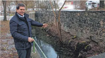  ?? SZ-FOTO: SVEN KOUKAL ?? Vorsitzend­er und Leiter der Urspringsc­hule, Rainer Wetzler, an der Stelle, an der spätestens zum 90-jährigen Jubiläum nächstes Jahr das Wasserrad stehen soll.