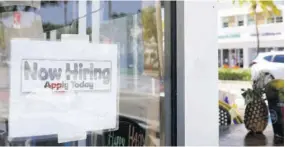  ?? (Photo: AP) ?? A “Now Hiring” sign is shown in the window of a restaurant, Thursday, January 7, 2021, in Miami Beach, Florida.