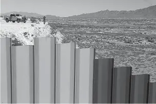  ?? AP Photo/Christian Torres ?? n A border patrol agent scans an area near the Mexico-U.S. border fence Jan. 25 on the Mexican side, separating the towns of Anapra, Mexico, and Sunland Park, N.M. House Republican­s are moving next week to fund President Donald Trump’s $1.6 billion...