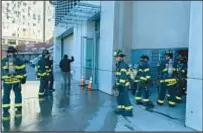  ?? CAYLA BAMBERGER FOR NYDN ?? Firefighte­rs on the wet scene at the Whitney Museum in the Meatpackin­g District on Saturday.