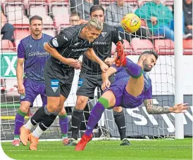  ??  ?? Hibs’ Adam Jackson scores with a spectacula­r overhead kick